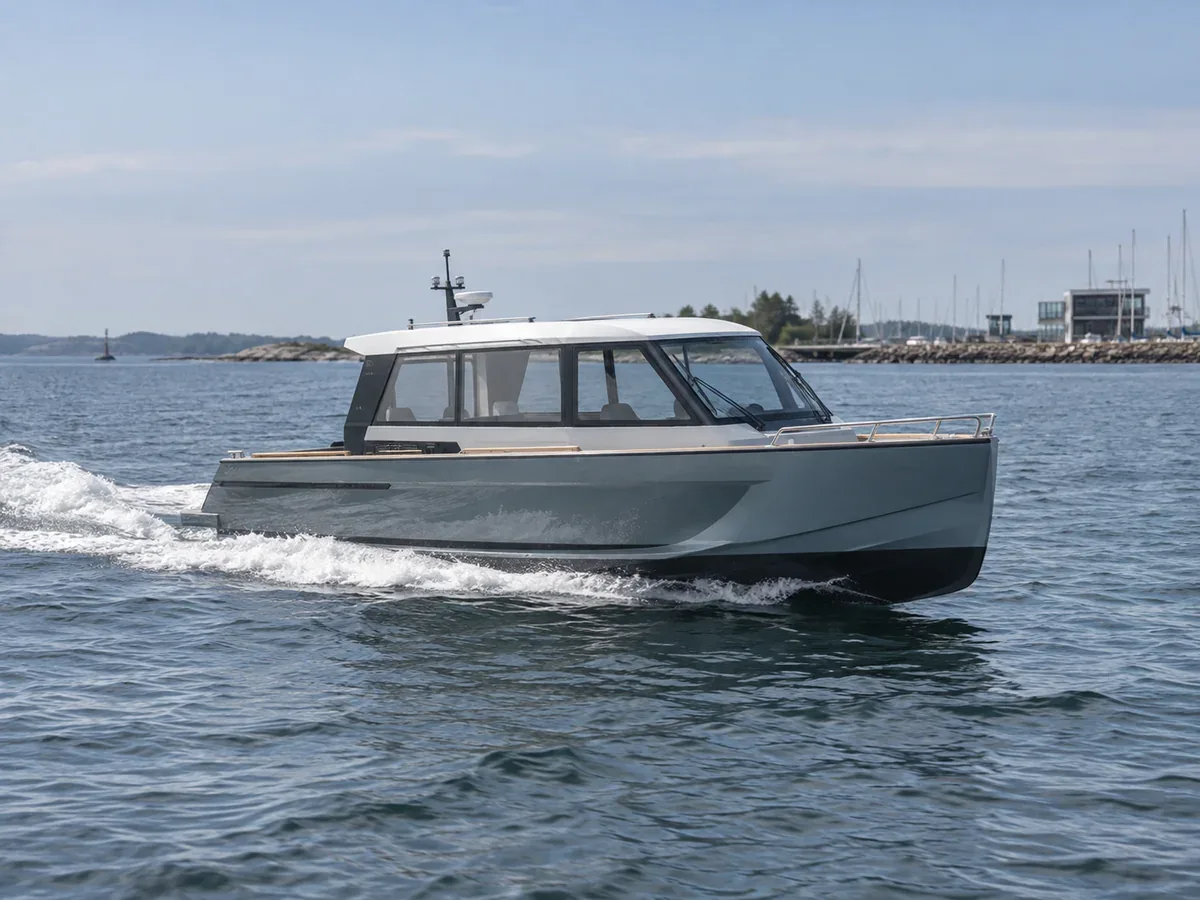 Modern electric inboard boat underway near a technical marina